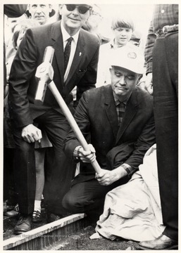 Portrait of man in hardhat pounding the last spike in the Bald Knob extension of Cass Scenic R.R.; photograph from John P. Killoran, Promotion Officer, WV State Parks, Charleston, WV 25305.