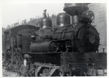 Ivan Clarkson standing next to train engine. Sunday afternoon; Ivan Clarkson Collection.