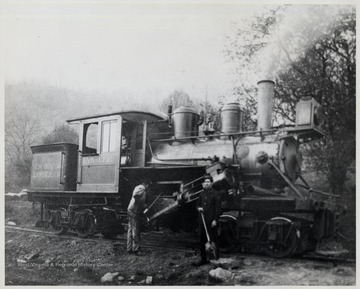 Diana, West Virginia.  Two men standing in front of train engine.