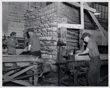 Three men sorting lumber.  L to R, 1. Alex Duncan 2. Sherwin Lambert 3. Cammern Ware.