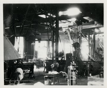 Machinery and tools inside railroad repair shop.