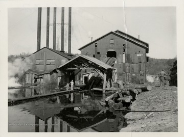 Back of the mill. Log slide down to the log pond.