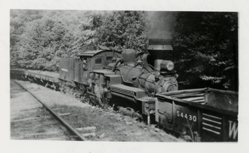 Train engine with conductor looking out the window.  