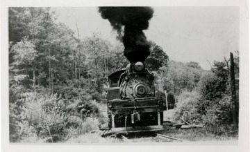 Train engine on tracks from the front.  