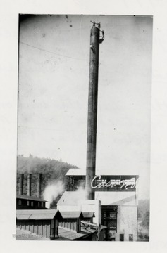 Three men standing on top of a stack.  Cass, WV.  