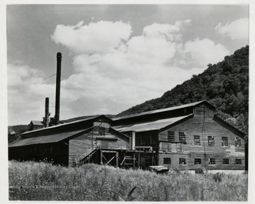 Earl Palmer, "Blue Ridge Mt's Roamin' Cameraman," Cambria, Va.  'This decaying building was once the worlds largest double bandmills'.  During the hey-day of operations at Cass, 2500 men worked here and in the woods round about, turning out a quarter million feet of wood products per day, working two 10 hour shifts.  Nowadays the old bldg. is an object of curiousity amongst thousands of rail fans who pass by on logging train excursions to Bald Knob.