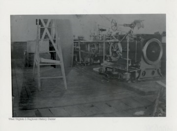 Machinery and ladder visible in a mill.  