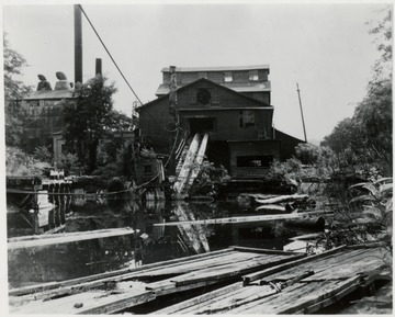 Out of Service Since 1961.  Built 1922-23.  Mill from pond side, in state of disrepair.  