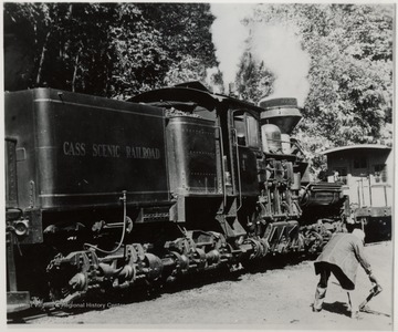 C.S.R. Engine at the switch.  Man bending over beside it.