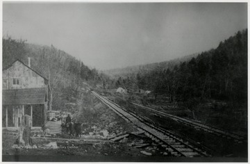 Railroad tracks beside a building.