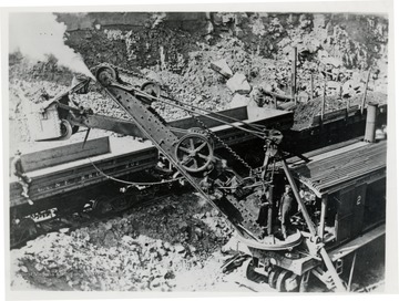 Man working a steam shovel.