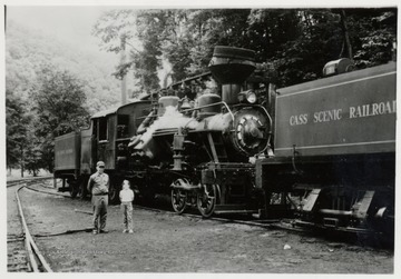 Kyle Neighbors and Wendy standing beside a train engine.