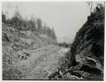 Marion Steam Shovel and Shay in Big Cut rear view at distance.  'Shovel is near the end then track is thrown in low place and shovel is brought back to start where track is now.'