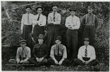 Standing right to left in the woods:  1. Geo Cromet  2. Ralph Riddle  3. Pat Lannan  4. Fred Lannan  5. --  Sitting right to left:  6. Charley Sealey  7. Larnce? Bradley  8. Andy Berriel  9.  Jess Tuesey?  