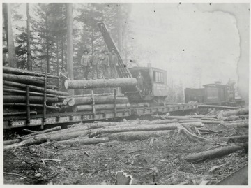 "W.Va. Spruce Lumber Company.  American Log Loader,  Model C, No. 2" on loader.  "Greenbrier and Elk River Railroad 39" on car. "Greenbrier and Elk River Railroad" on engine.  Log loader, engineer, John Geraw.  Engine 2, engineer, Lewis Collins.  Fireman, Robert Dean.