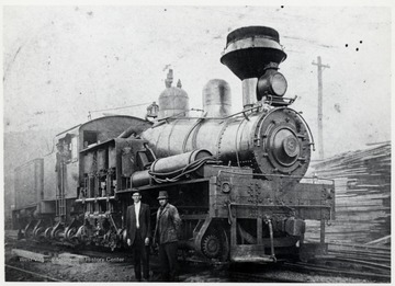 Shay train engine at the Cass Mill Yard in Cass, W.V.  Foreground:  1. Slim Snyder  2. Charlie Craddock. Men in the Cab of No. 8:  1.?  2.?