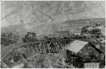 Train pulling lumber carts in Dobbin, W.Va.