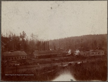 Mill with six smoke stacks visible.