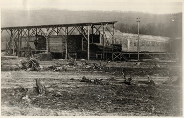 Lumber piles on a covered dock.