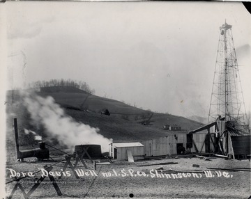 Oil derrick and adjoining oil company buildings.  