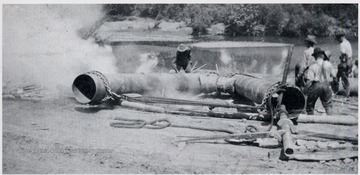 Men working on oil pipe.