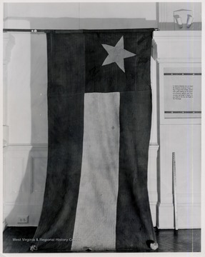 Battle flad captured at Philipi, W.Va.  Print from original in Battle Abbey, Richmond, Va.  Information beside flag reads:  In soldierly fellowship here are draped the standards of unknown troops, -a flag of Virginia that probably marked some public building and the banner of an Arkansas regiment saved from surrender and brought to Virginia to pay tribute to the men who fought on The Mississippi.