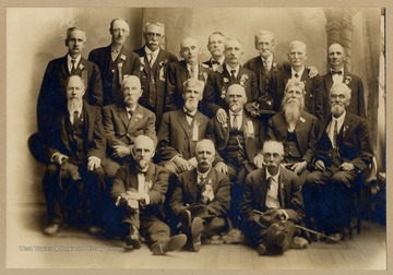 Members of Co. A., 12th W.Va. Infantry.  Standing:  Philip McCleary Pelley, *Wm. Magers, John Trenter*, George Gossett, *John C. Crow, C.C. Mathews, Mahlon Geurin, Abram Jones*, Wm. H. Dorsey*.  Seated on chairs:  Alex Connor, Absolem Crow, John G. Jones*, John Robert Talbert, James Logsdon, Daniel Morris.  Seated on floor:  Timothy B. Baker, Bill Stein, John W. Edwards*.  *= Decea.