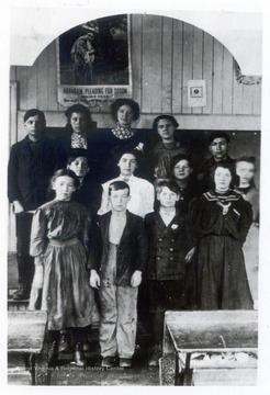 Students and a teacher in a classroom.