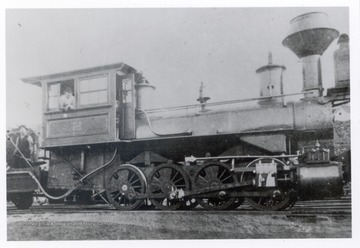 1800 train engine with crew member in the cabin.