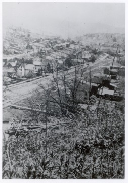 Birdseye view of logging town and train tracks.