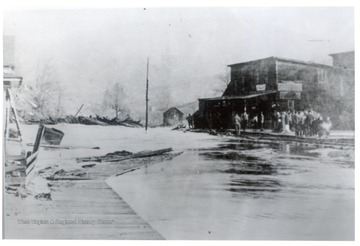 Crowd viewing flood waters in town. 