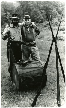 The 7th West Virginia Infantry, USV, calls a truce with the 12th Virginia Cavalry, CSA. Bob Goodwin, left, Yankee doughboy, and Ed Gaskins, Confederate horse soldier, leaders of the Morgantown Muzzle Loaders Club, take time out while on a field trip. See West Virginia Collection Pamphlet 6610 and Boyd Stutler's 'West Virginia in the Civil War.'