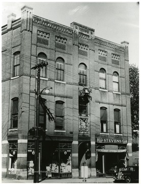 The John Brown Bell at Marlborough, Massachusetts, hanging over the street from the top of the second story window of the Grand Army Legion Building. It was 'liberated' by Marlborough men in 1861, but it was thirty years before it reached their home city. See West Virginia Collection Pamphlet 6610 and Boyd Stutler's 'WV in the Civil War.'