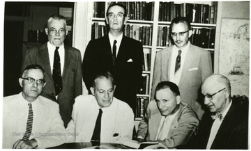 Group portrait of the Civil War Centennial Commission, created to plan and coordinate the series of observances and commemoration of VA centenary of the Civil War in West Virginia. Seated left to right: George N. Cobbs, S. Charlston; Major Thorton T. Perry, Jr, Charles Town; Colonel J.W. Benjamin, Lewisburg; and Delf Norona, Moundsville, Secretary-Treasurer. Standing left to right; Boyd Stutler, Charleston; Judge Charles W. Fergerson, Wayne; and Dr. E.E. Myers, Philippi, Chairman.  See West Virginia Collection Pamphlet 6610.