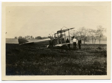 Louis Bennett, Jr. and others wait next to plane at Sheepshead Bay.