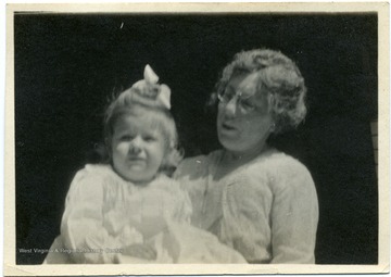 Candid portrait of grandmother and child, Agra Bennett, Jr.  This photograph was found in Louis Bennett, Jr.'s Royal Air Force wallet.