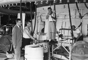 Men working inside Seneca Glass Factory. Photography by Richard Phillips, Morgantown, West Virginia. 