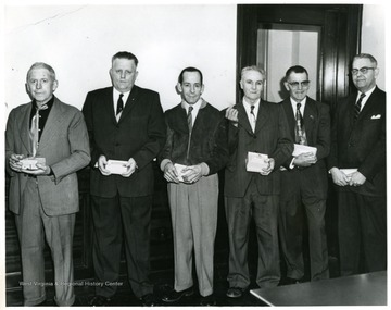 Group portrait of glass workers in the Fostoria Glass Company.