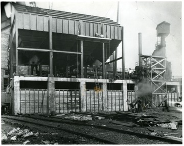 Outside of the Fostoria Glass Company with a few workers present.