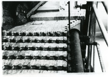 Pipes running along side the exterior of a wall.