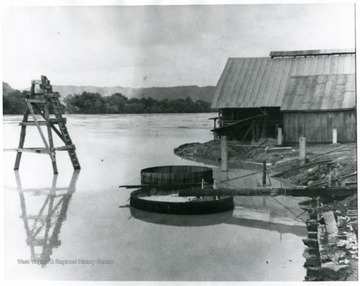 A brine storage reservoir with a building on the rightside.