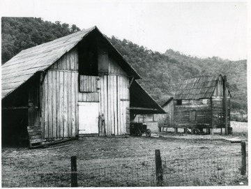 Barn with a tractor parked beside it as well as a salt dryer building at Dickinson Salt Works. 