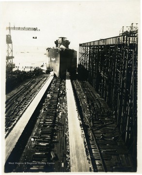 U.S.S. West Virginia leaving dry docks with a crowd of onlookers.