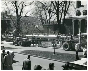 Picture of the Mast of the U.S.S. West Virginia pictured in front of Elizabeth Moore Hall at Friday noon, March 17, 1961.