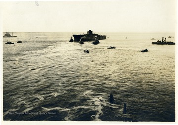 The U.S.S. West Virginia at sea moments after her launch in November 1921, surrounded by support craft. The battleship, nicknamed the "Wee Vee", was commissioned in December 1, 1923.