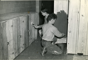 Two Sunnyside School boys painting kitchen cabinets in Mason County. 