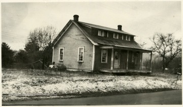 House in Pocahontas County before the Outside Improvement project. This farm woman remarked, 'A house is no harder to paint than a piece of furniture. It just takes longer.' Most of the labor was done by this woman herself. (See photograph number 001560 to see home after renovations.)