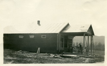 Home of Mrs. C.J. Brumagin on the edge of the Buckeye community when they first bought the house. The Brumagin's started their home from a building originally intended for a store  and a gas station. Mr. T.D. Gray assisted Mrs. Brumagin with her landscaping problems during April, 1946. Much of her work had already been completed but Mr. Gray's suggestions when carried out helped to make the farm home even more attractive.  (See photograph number 001575 for a later view.)