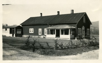 Home of Mrs. C.J. Brumagin on the edge of the Buckeye community after renovations. The Brumagin's started their home from a building originally intended for a store and a gas station. Mr. T.D. Gray assisted Mrs. Brumagin with her landscaping problems during April, 1946. Much of her work had already been completed but Mr. Gray's suggestions when carried out helped to make the farm home even more attractive. (See photograph 001574 for a view of the home before renovations.)