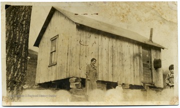 Home where Mrs. Watson moved in Monongalia County; woman and child in front of house.